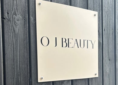 Modern O J Beauty sign against rustic wood wall in Gravesend, England, GB.