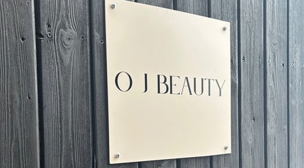 Modern O J Beauty sign against rustic wood wall in Gravesend, England, GB.