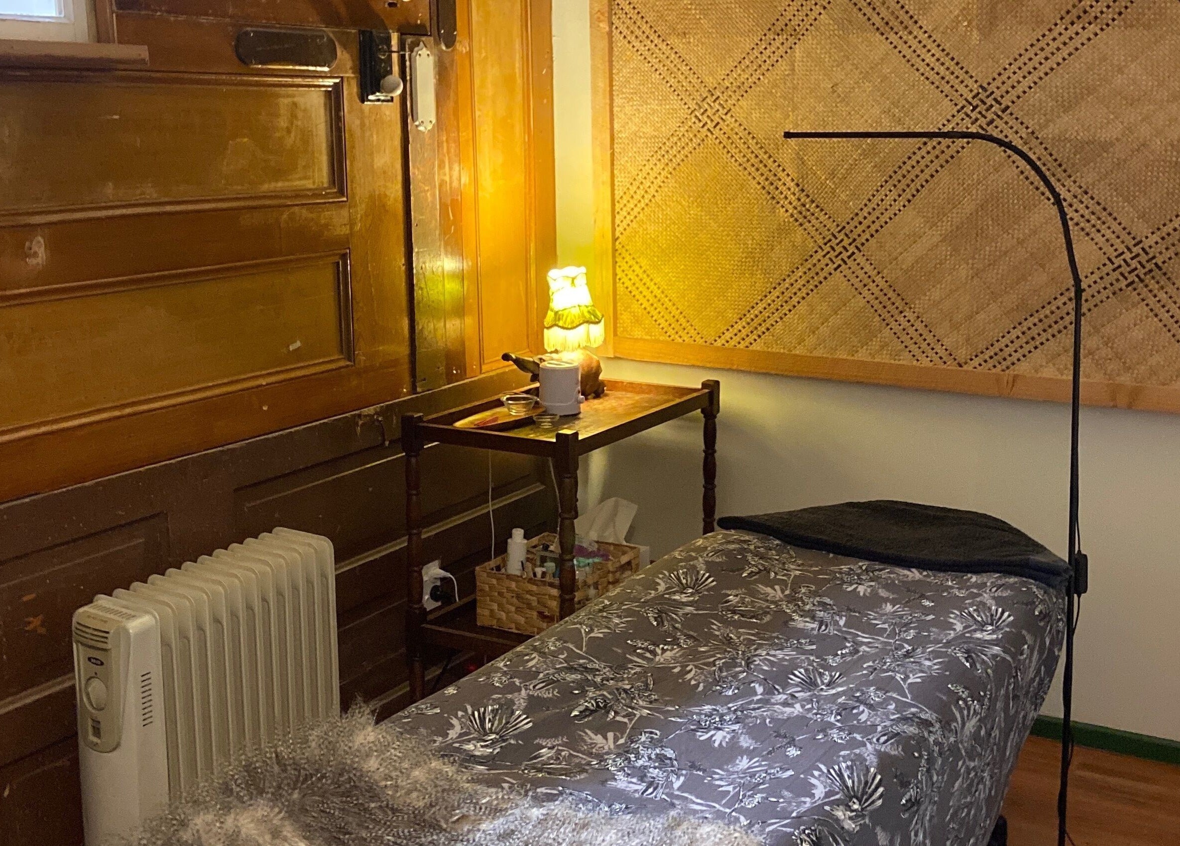 Relaxing therapy room at The Beauty Bach Invers, Invercargill, Southland Region, NZ with warm light and floral bedding.