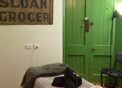 Relaxing massage room at The Beauty Bach Invers, Invercargill, Southland Region, NZ with green doors.
