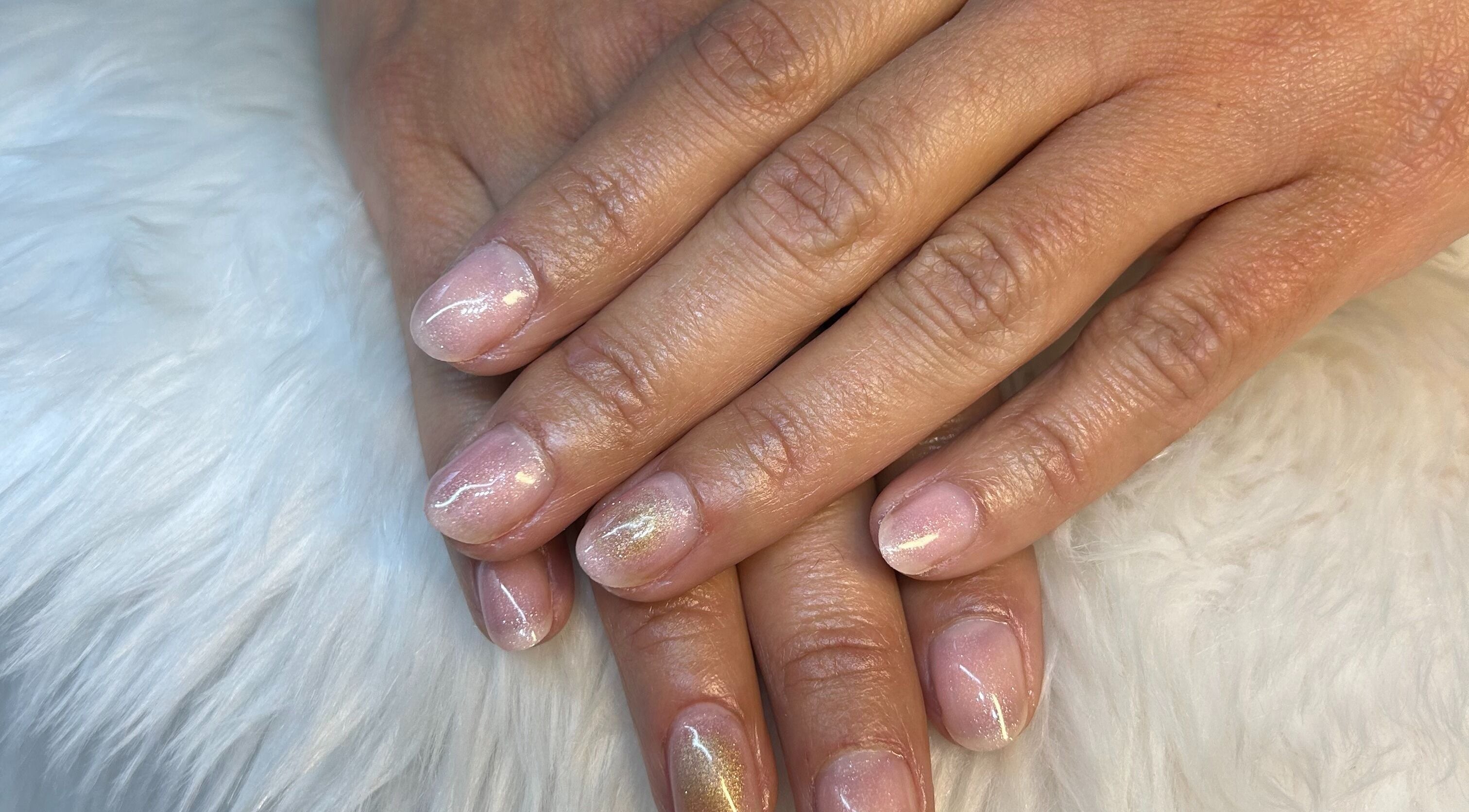 Gleaming nails at Beauty FX Nail Studio & Spa, Barrie, Ontario, CA. A soft pink manicure with shimmer accents.