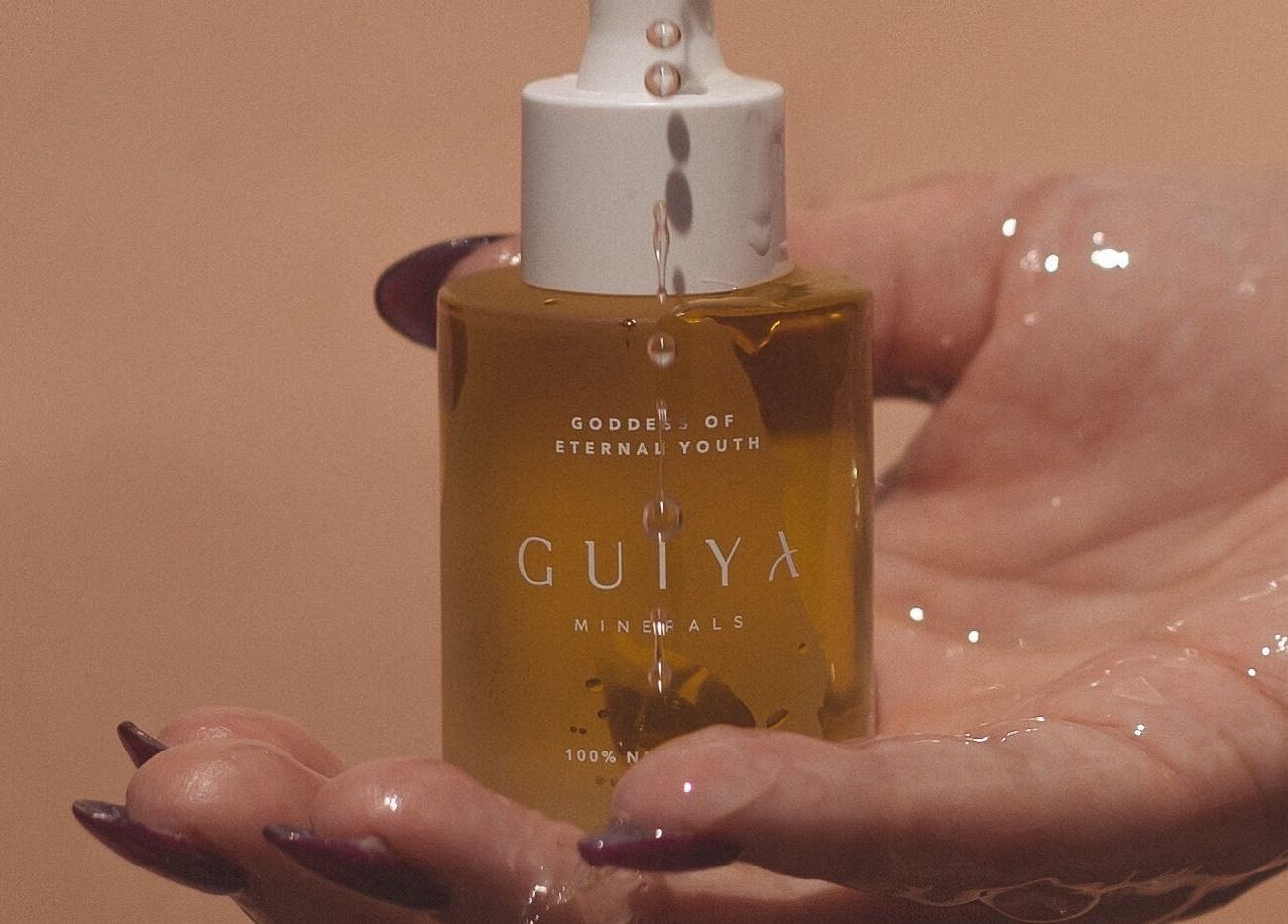 Golden beauty serum in hand at Ministry of Beauté, Kingsgrove, New South Wales, AU.