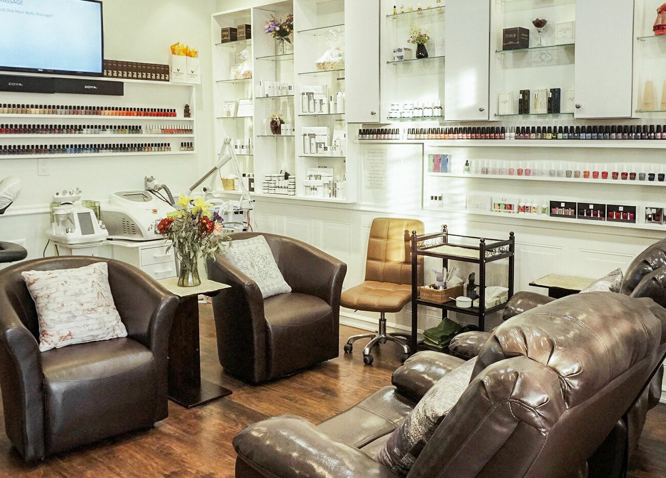 Relaxing nail salon at Pure Green Locust Valley, Locust Valley, New York, US, with brown leather chairs and nail polish display.
