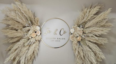 Beauty by Jo & Co salon sign with pampas grass arrangement in Adlington, England, GB.
