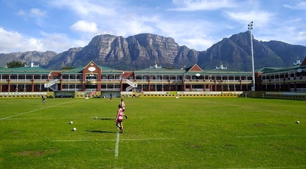 Scenic view of Villagers Football Club's sports field in Cape Town, Western Cape, ZA with mountain backdrop.