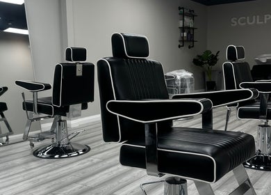 Modern black salon chairs at SCULPT, Newry, Northern Ireland, GB, reflecting luxury and comfort.