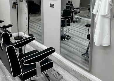 Stylish black salon chairs at Sculpt in Newry, Northern Ireland, GB, with modern decor and mirrors.