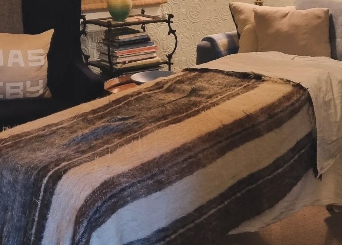 Cozy lounge area at Self Mind & Body, Dunedin, Otago, NZ, featuring plush seats and a warm throw.