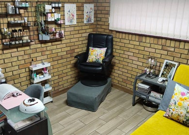 Cozy interior of Magnolia Beauty at Springs, Gauteng, ZA featuring a black chair, art, and beauty products.