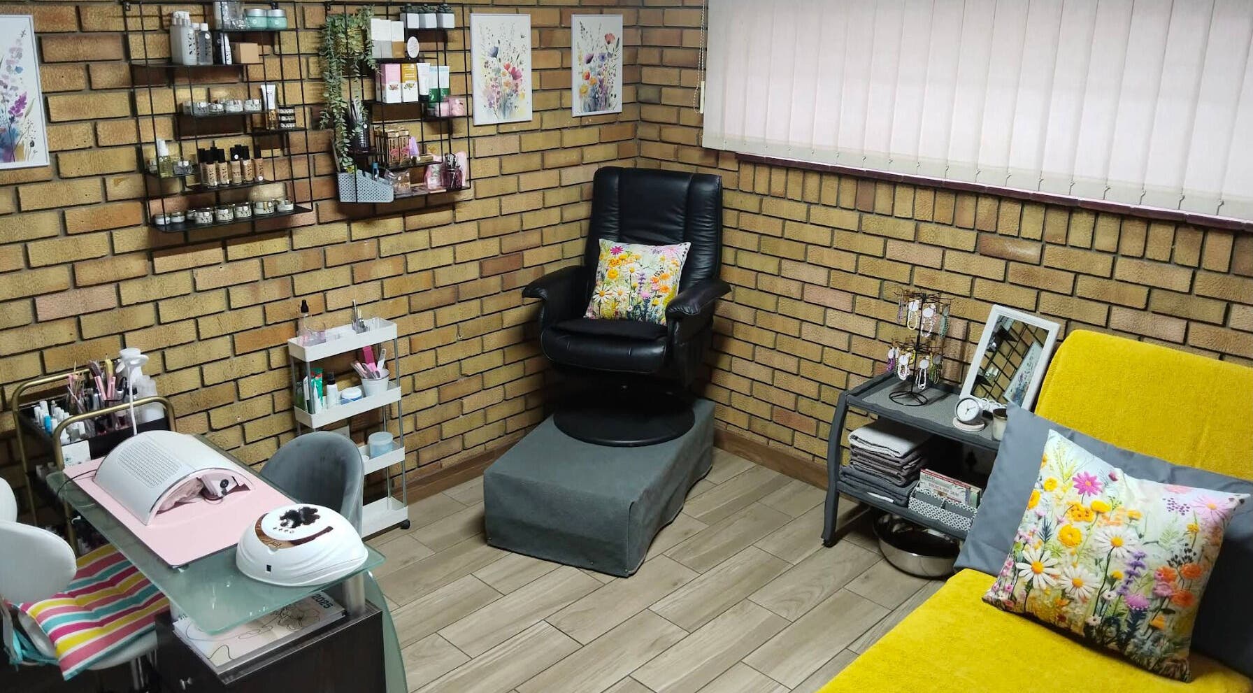 Cozy interior of Magnolia Beauty at Springs, Gauteng, ZA featuring a black chair, art, and beauty products.