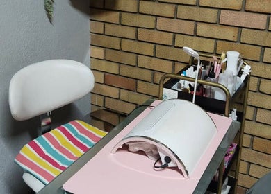 Modern nail station at Magnolia Beauty in Springs, Gauteng, ZA, featuring colorful cushions and nail tools.