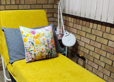 Cozy treatment chair with floral cushion at Magnolia Beauty, Springs, Gauteng, ZA. Ideal for a relaxing experience.