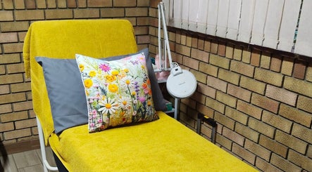 Cozy treatment chair with floral cushion at Magnolia Beauty, Springs, Gauteng, ZA. Ideal for a relaxing experience.