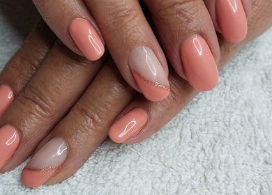 Elegant coral manicure at Magnolia Beauty, Springs, Gauteng, ZA. Sophisticated nail design with gloss finish.