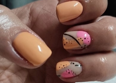 Colorful nail art at Magnolia Beauty, Springs, Gauteng, ZA with peach and pink designs.