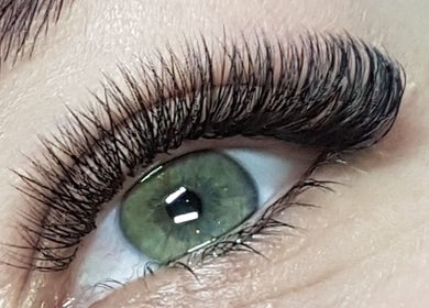 Close-up of eyelash extensions from Enigma Prestige Beauty in Newbury, England, GB showcasing elegant green eye.