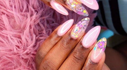 Vibrant floral nail art at Kreative Tips and Toes, Providenciales, TC, showcasing intricate designs on pink nails.