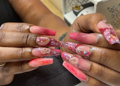 Stylish, intricate nail art at Kreative Tips and Toes, Providenciales, TC with pink and floral designs.