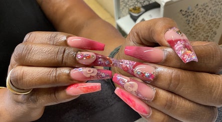 Stylish, intricate nail art at Kreative Tips and Toes, Providenciales, TC with pink and floral designs.