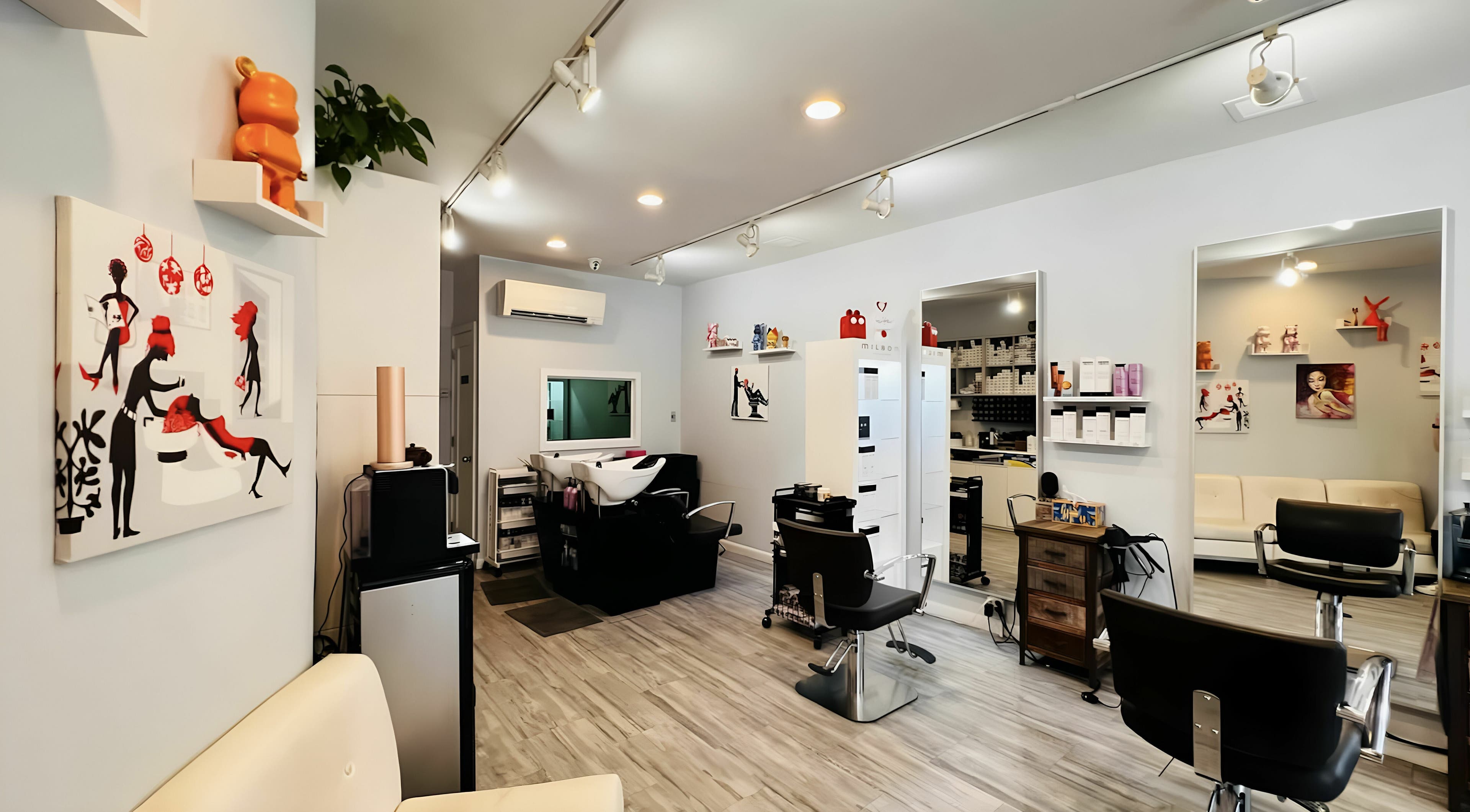 Modern interior of R Hair Studio in New York, New York, US with stylish decor and salon chairs.