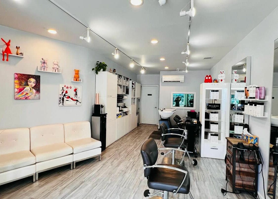 Modern interior of R Hair Studio in New York, New York, US featuring sleek chairs and vibrant decor.