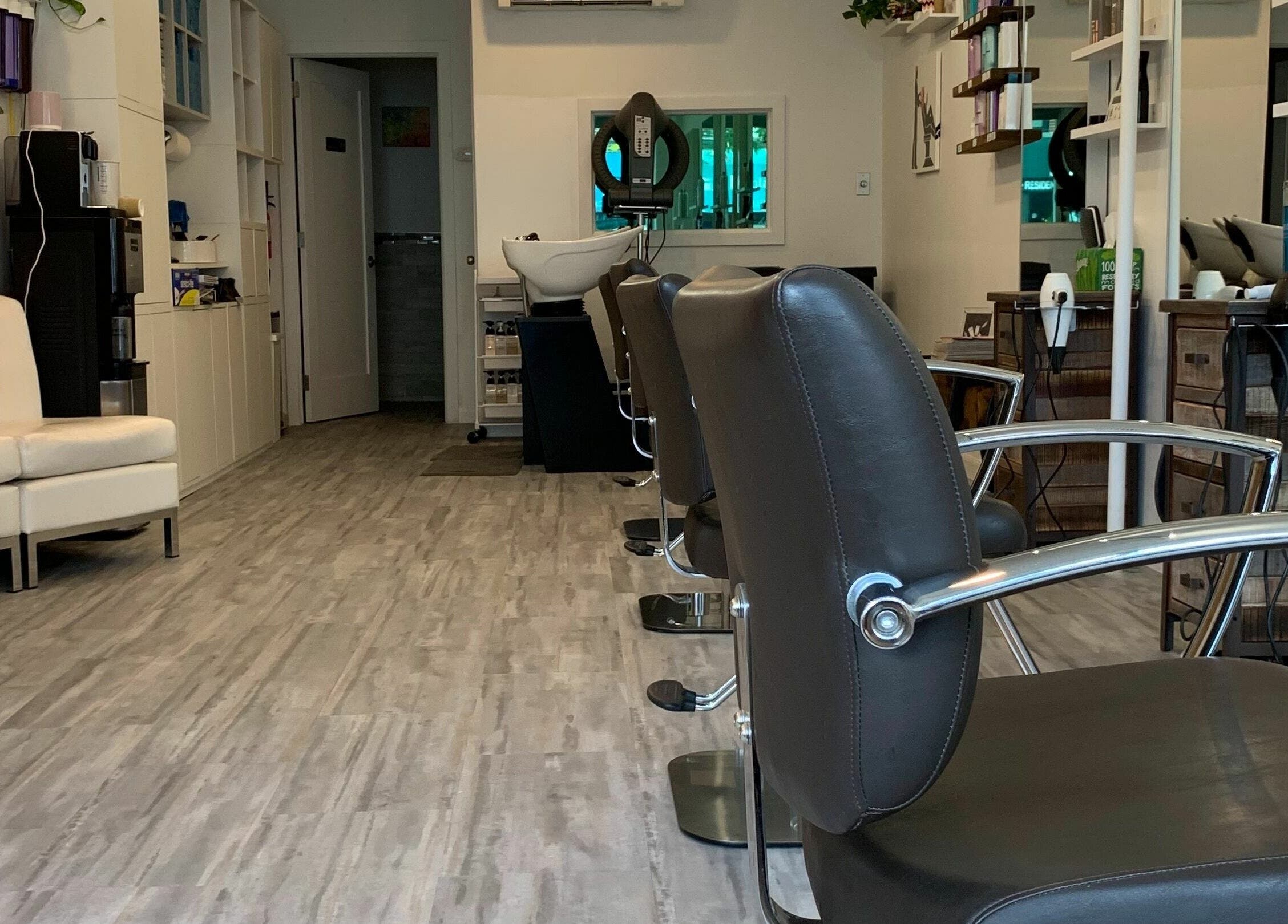 Sleek salon chairs and modern decor at R Hair Studio in New York, New York, US.