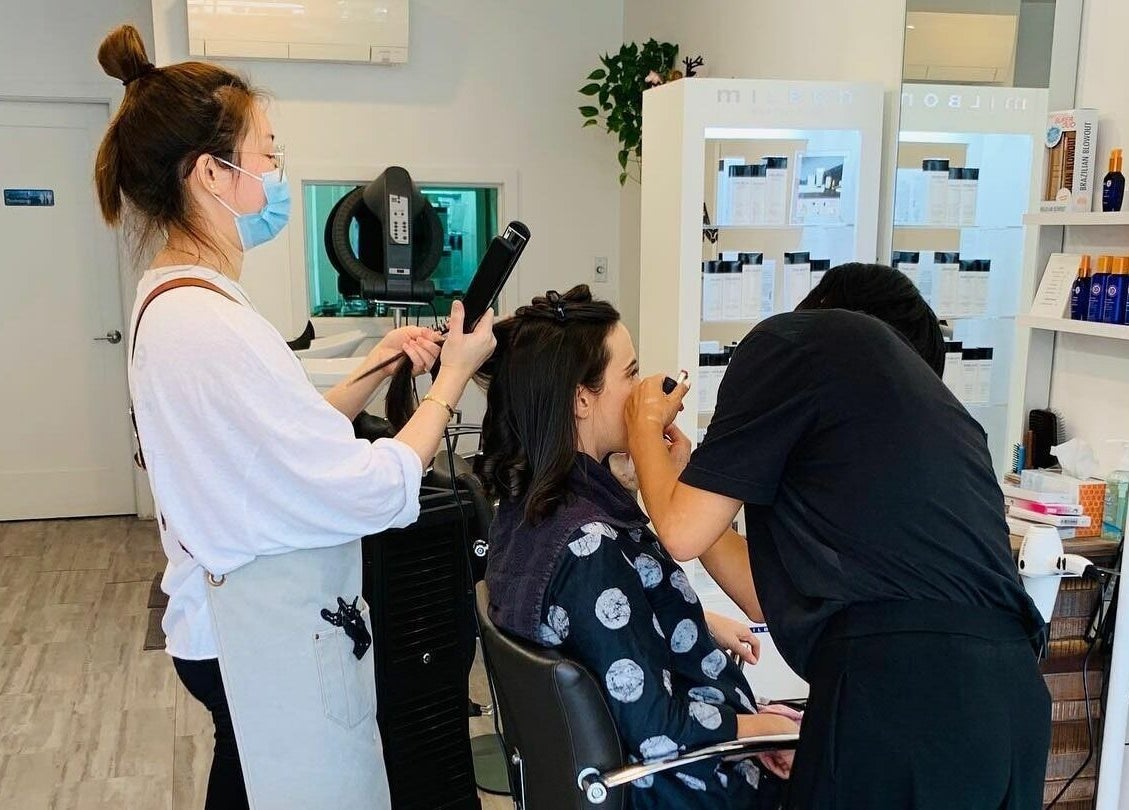 Stylists at R Hair Studio, New York, NY, US, provide hair and makeup services to a client.