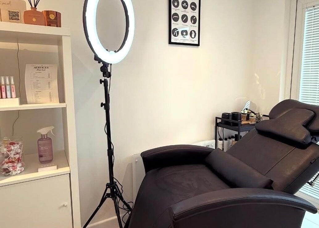Relaxing treatment room at LVC Beauty, Aberdeen, Scotland, GB, featuring a reclining chair and soft lighting.