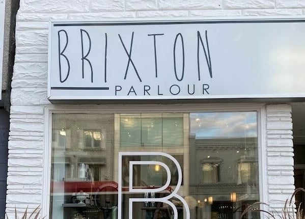 Exterior of Brixton Parlour with signage in Toronto, CA showcasing modern elegance and style.