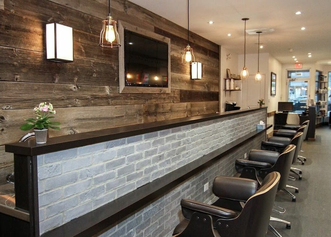 Chic, rustic interior of Brixton Parlour in Toronto, CA featuring modern lighting and seating.