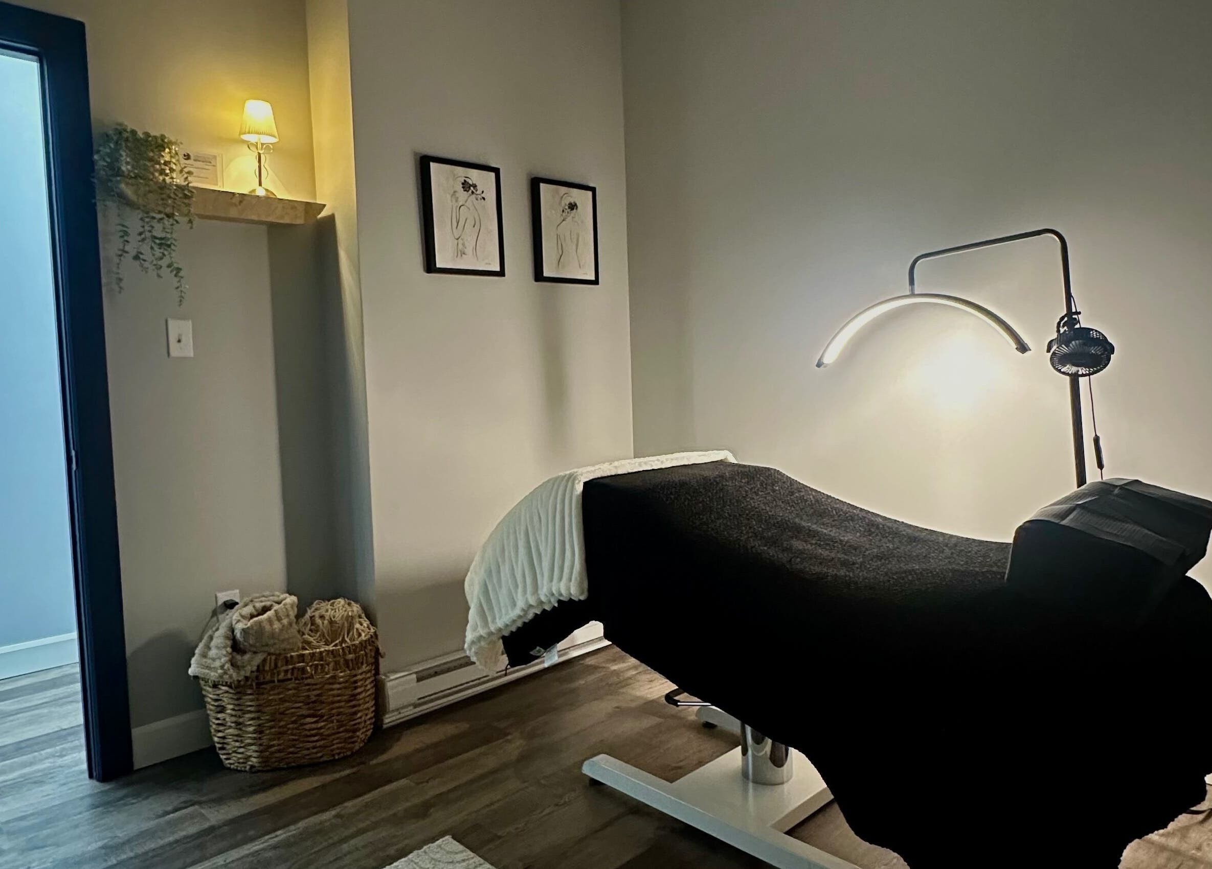 Comfortable treatment room at LashedWithHailey, North Sydney, Nova Scotia, CA, featuring a massage table and soft lighting.