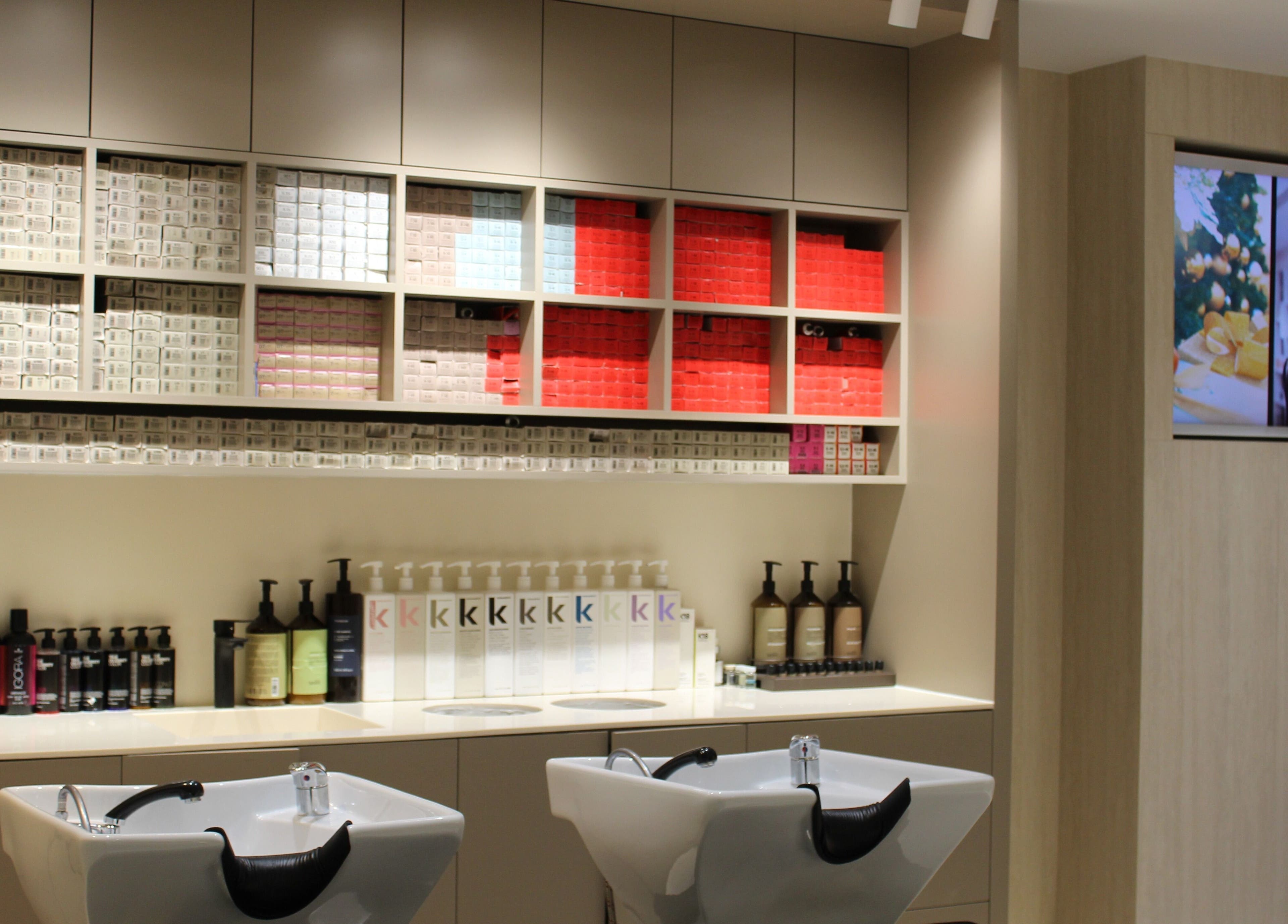 Elegant wash station at Vita Lita Beauty Salon, Dubai, AE, showcasing products and modern decor.
