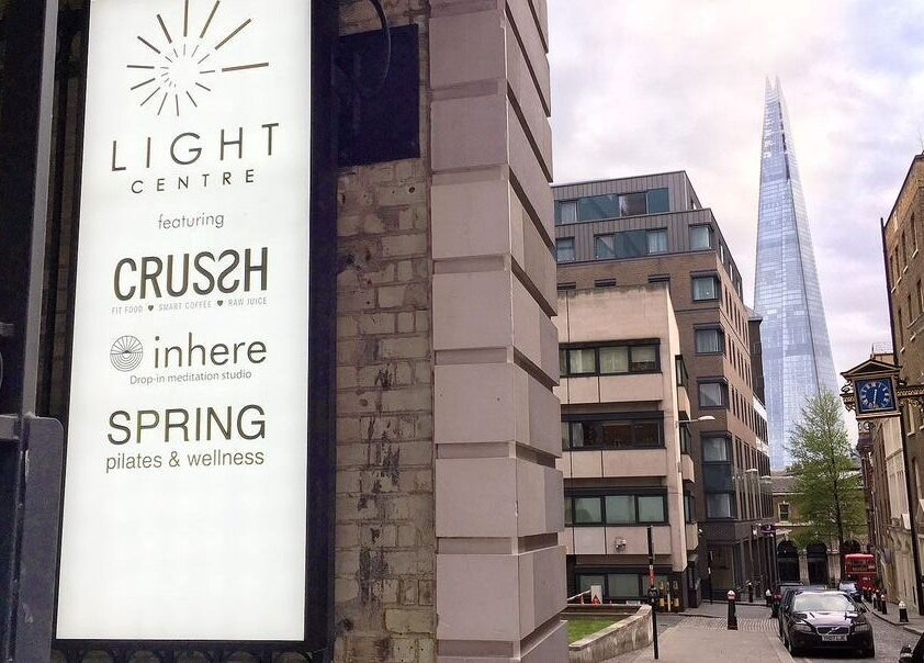 View of Light Centre sign with cityscape near Danugur Monument (The City), London, England, GB.