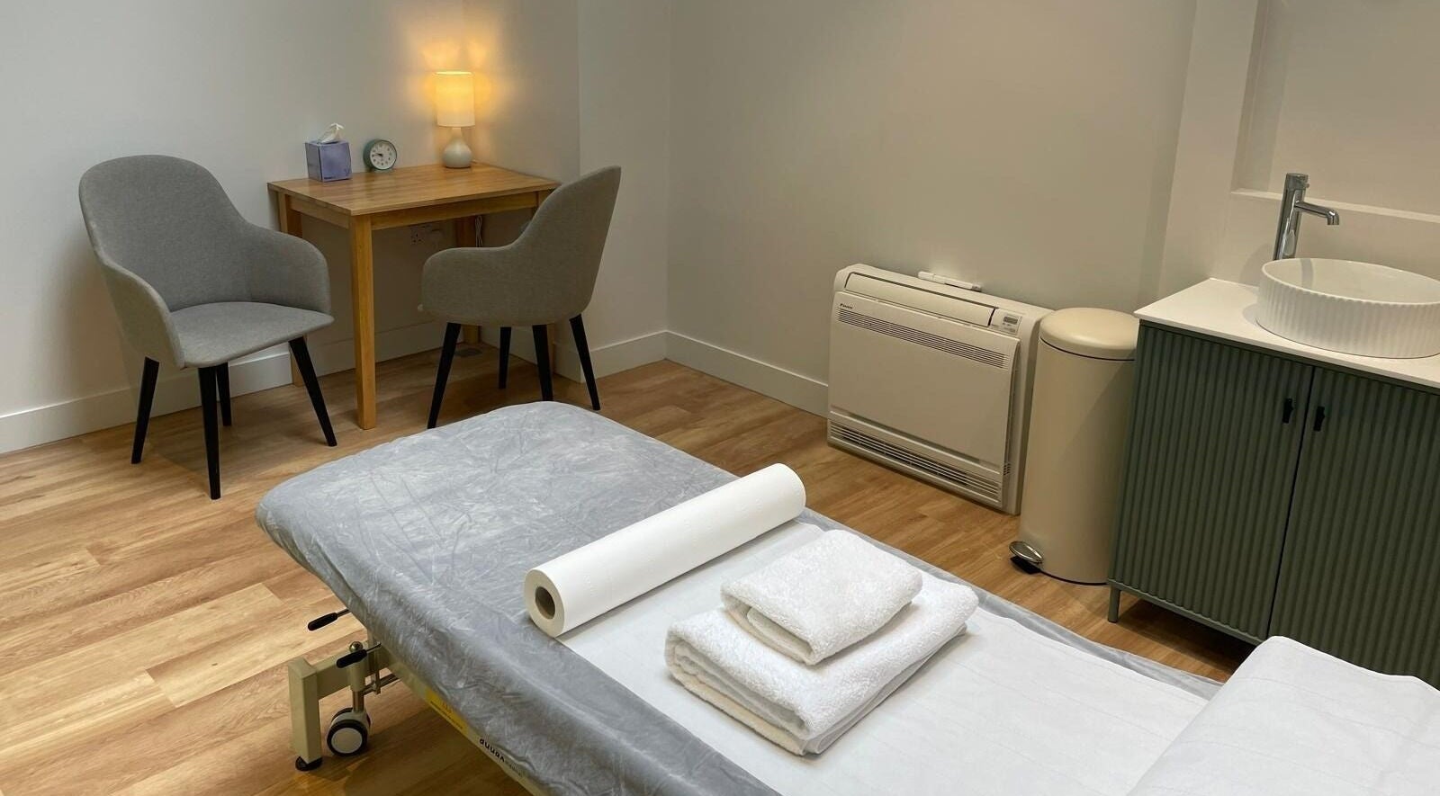 Cozy therapy room at Danugur Old Street in London, England, GB with massage table and soft lighting.