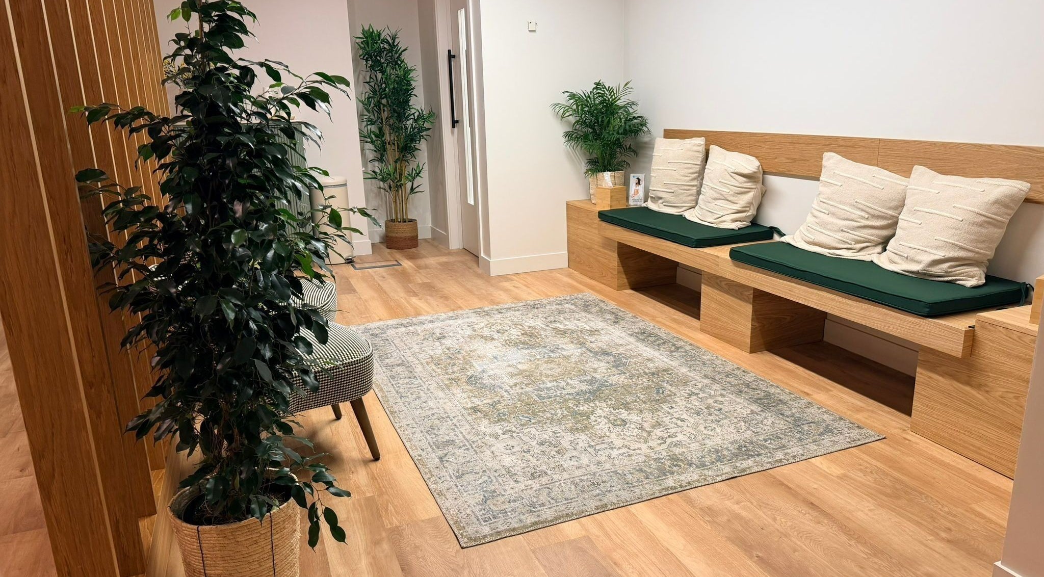 Cozy seating area in Danugur Old Street, London, England, GB, with plants and wooden bench.