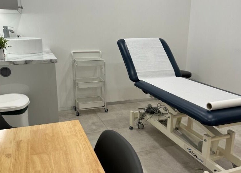 Treatment room at Mean (Men) Mareylebone in London, England, GB featuring a massage table and modern decor.