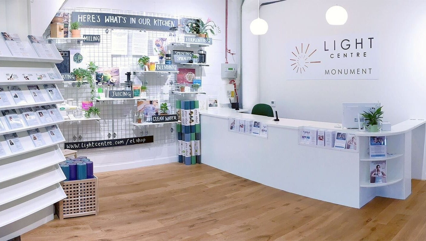 Reception area of Maen Monument in London, England featuring a modern wellness setup with informational displays.