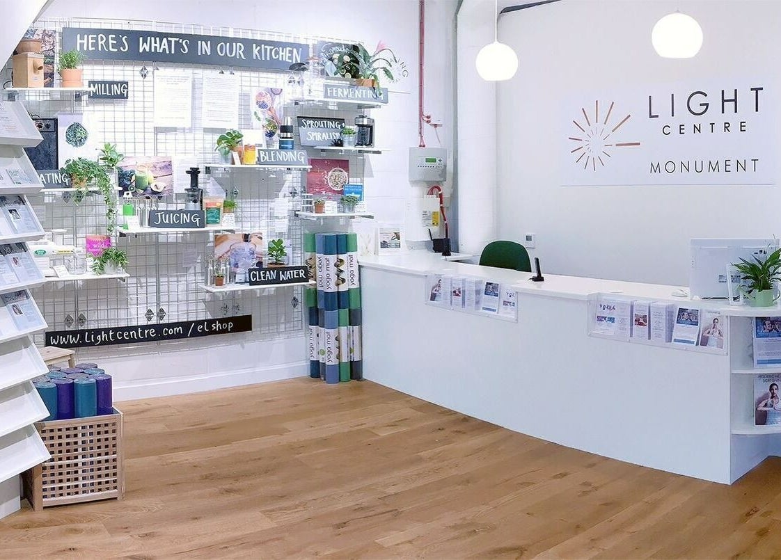 Reception area of Maen Monument in London, England featuring a modern wellness setup with informational displays.