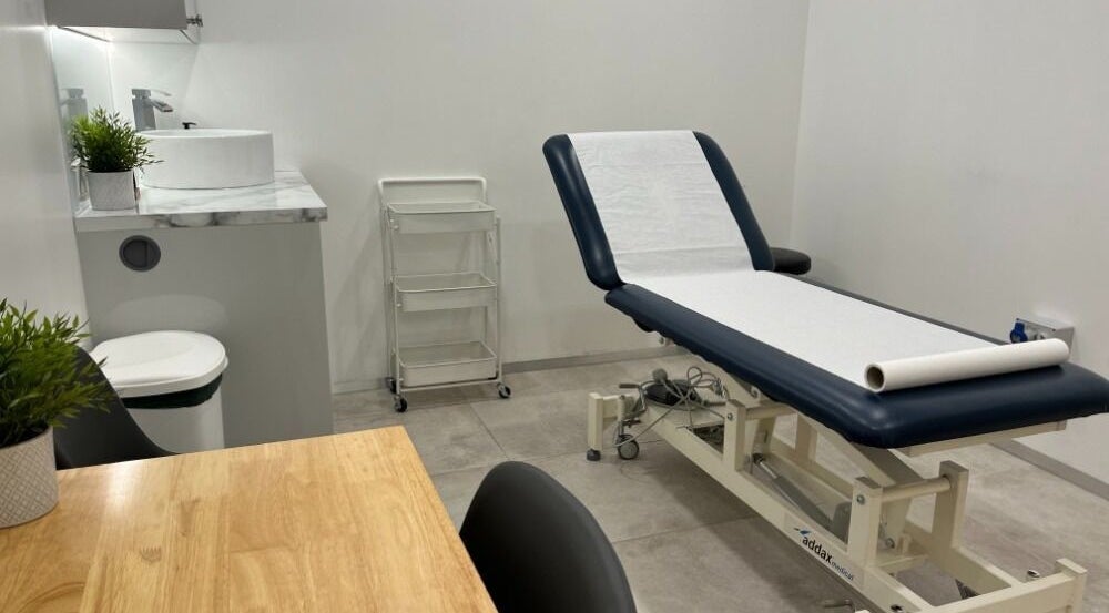 Modern treatment room at Maen Men Mareylebone, London, England, GB featuring a treatment bed and sink.