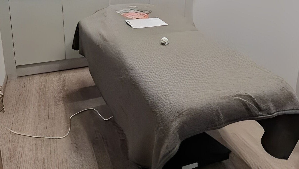 Massage table at Maen Men South East London, located in London, England, GB, featuring a cozy fleece cover.