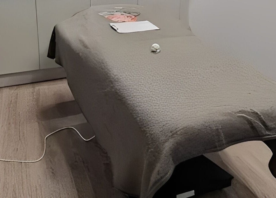 Massage table at Maen Men South East London, located in London, England, GB, featuring a cozy fleece cover.