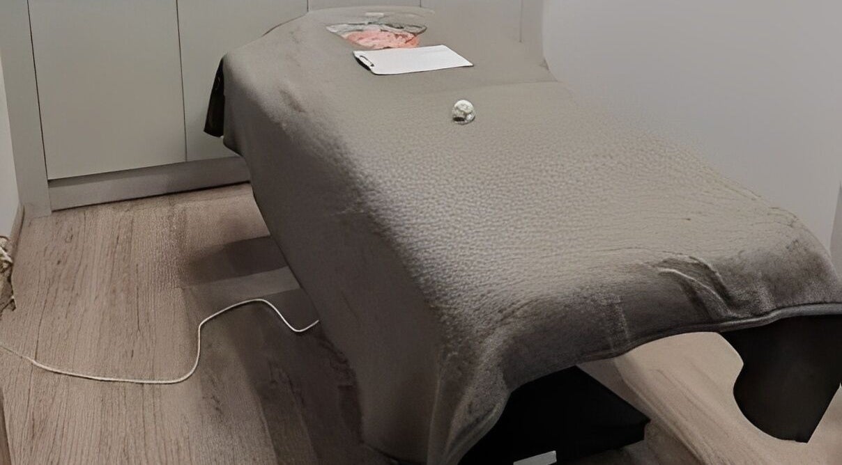 Massage table at Maen Men South East London, located in London, England, GB, featuring a cozy fleece cover.
