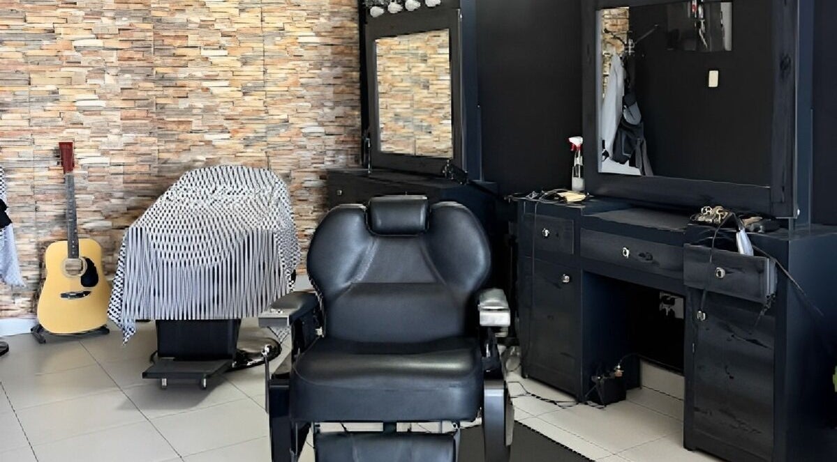 Interior de Georgie Barbershop en Hermosillo, Sonora, MX, con silla de barbería y decoración elegante.