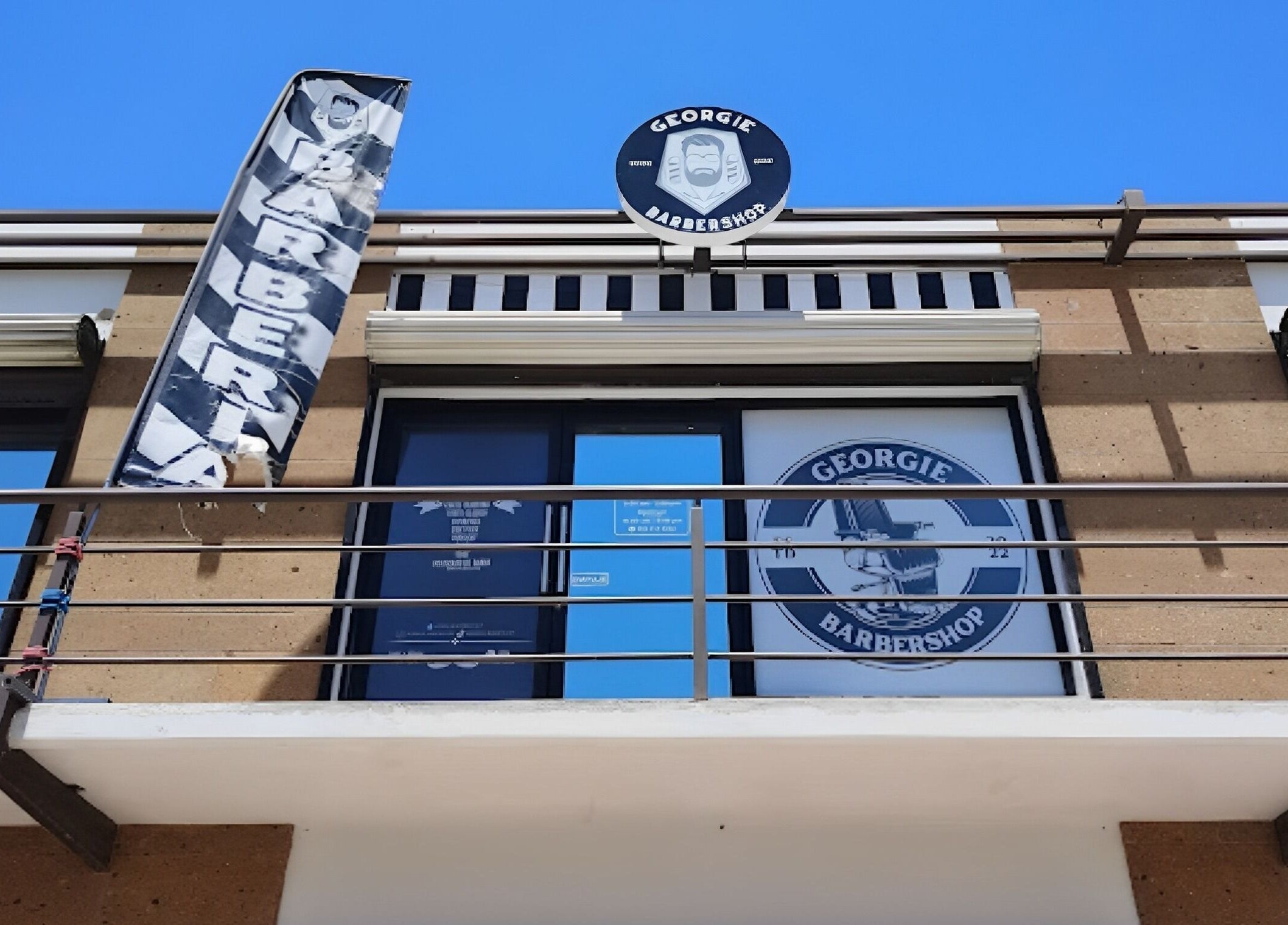 Fachada de Georgie Barbershop en Hermosillo, Sonora, MX, mostrando su letrero distintivo.