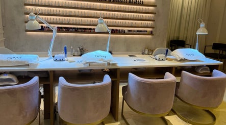 Luxurious manicure station at Nevvi Beauty Salon, Riyadh, SA, featuring elegant decor and comfortable seating.