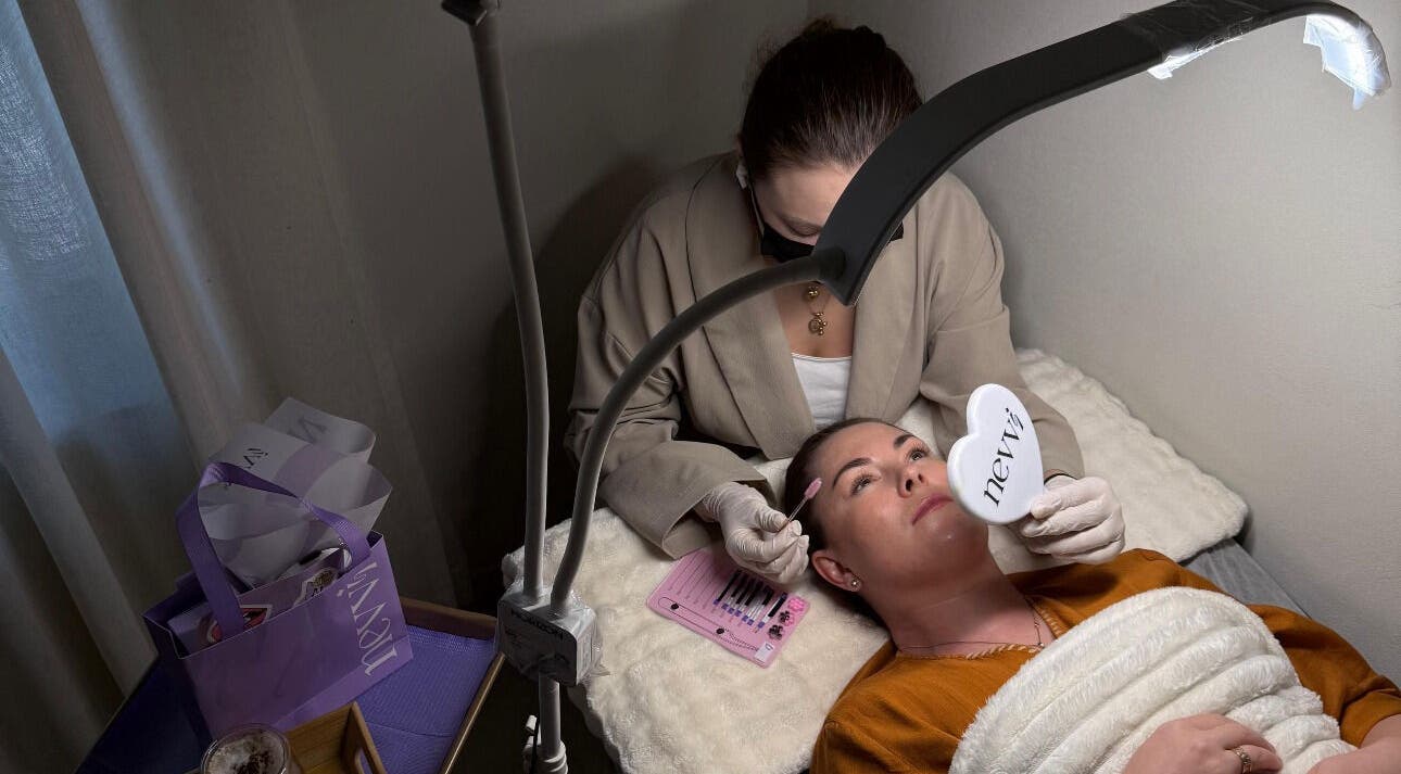 Beauty treatment session at Nevvi Beauty Salon, Riyadh, SA. Client holds heart-shaped mirror during service.