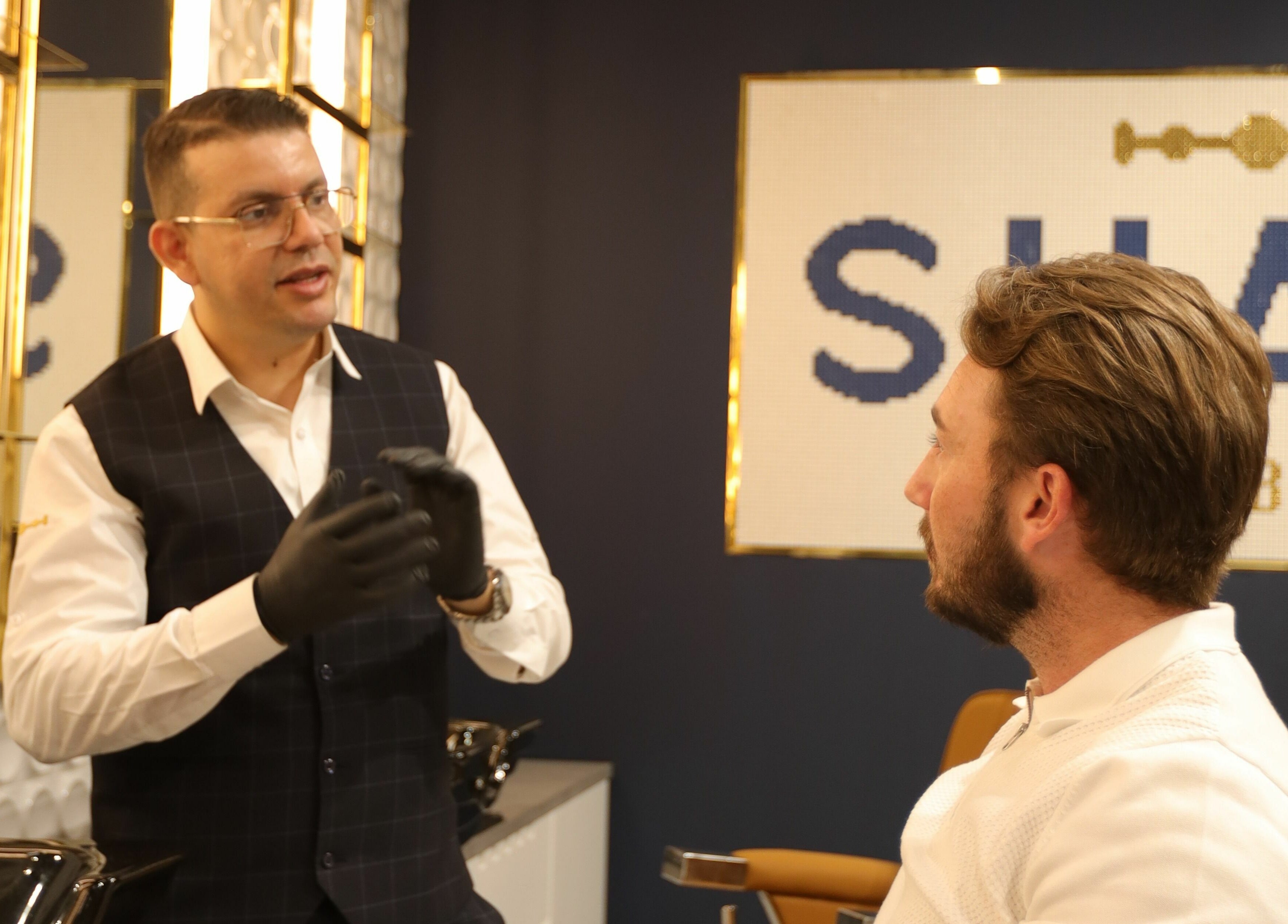 Stylist consulting client at Shave Barbers - City Walk, Dubai, Dubai, AE. Elegant and modern interior.