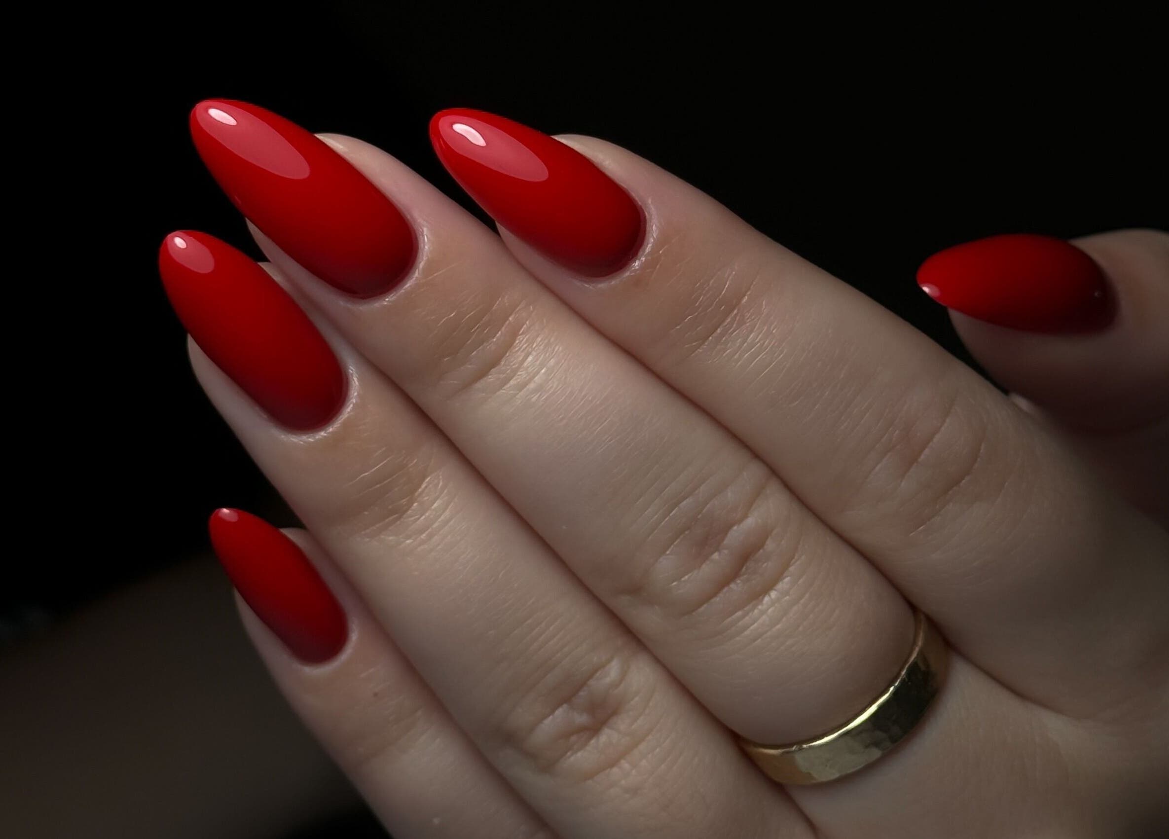 Glossy red manicure at Cupid Nail Studio, Varsity Lakes, Queensland, AU showcases professional beauty services.