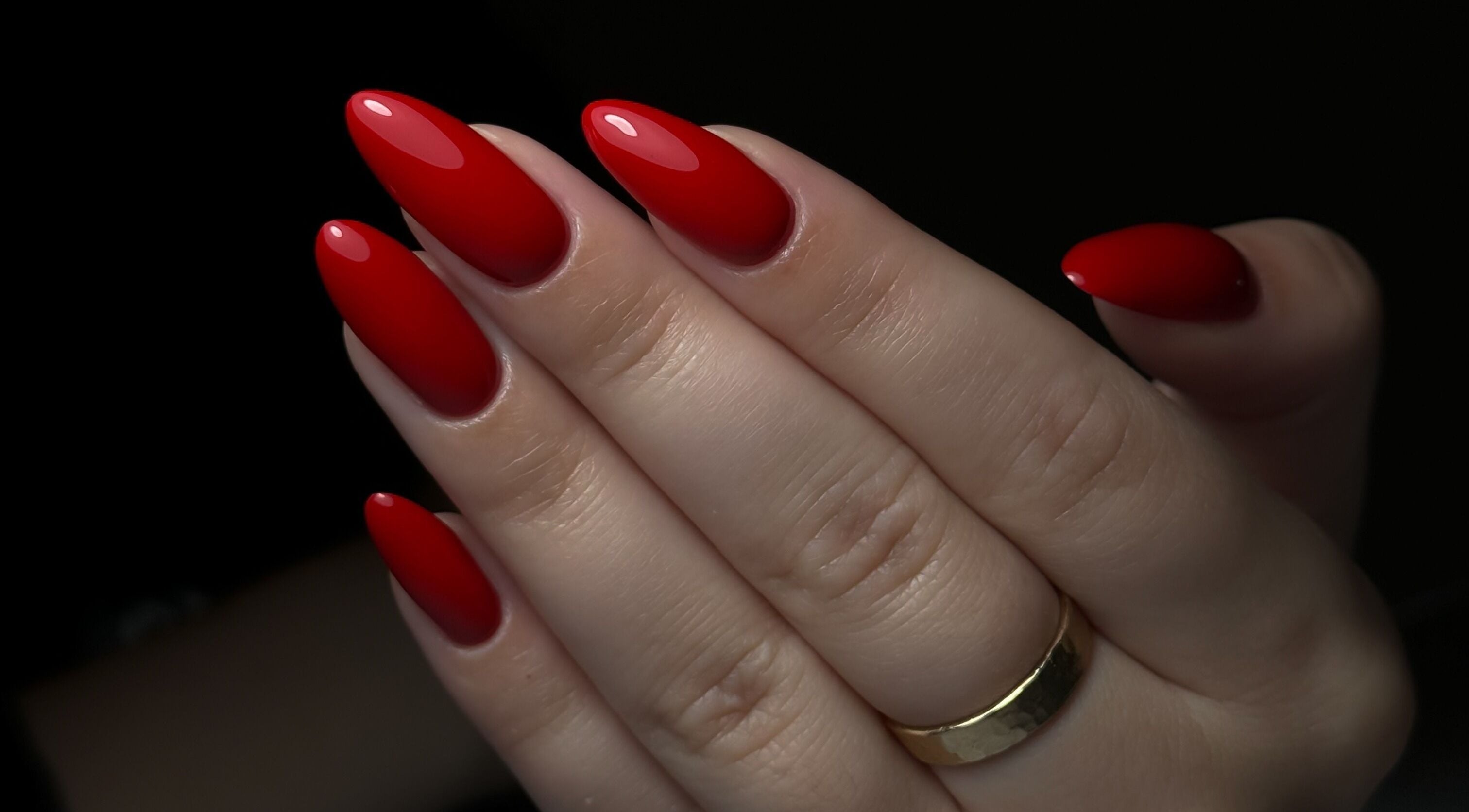 Glossy red manicure at Cupid Nail Studio, Varsity Lakes, Queensland, AU showcases professional beauty services.