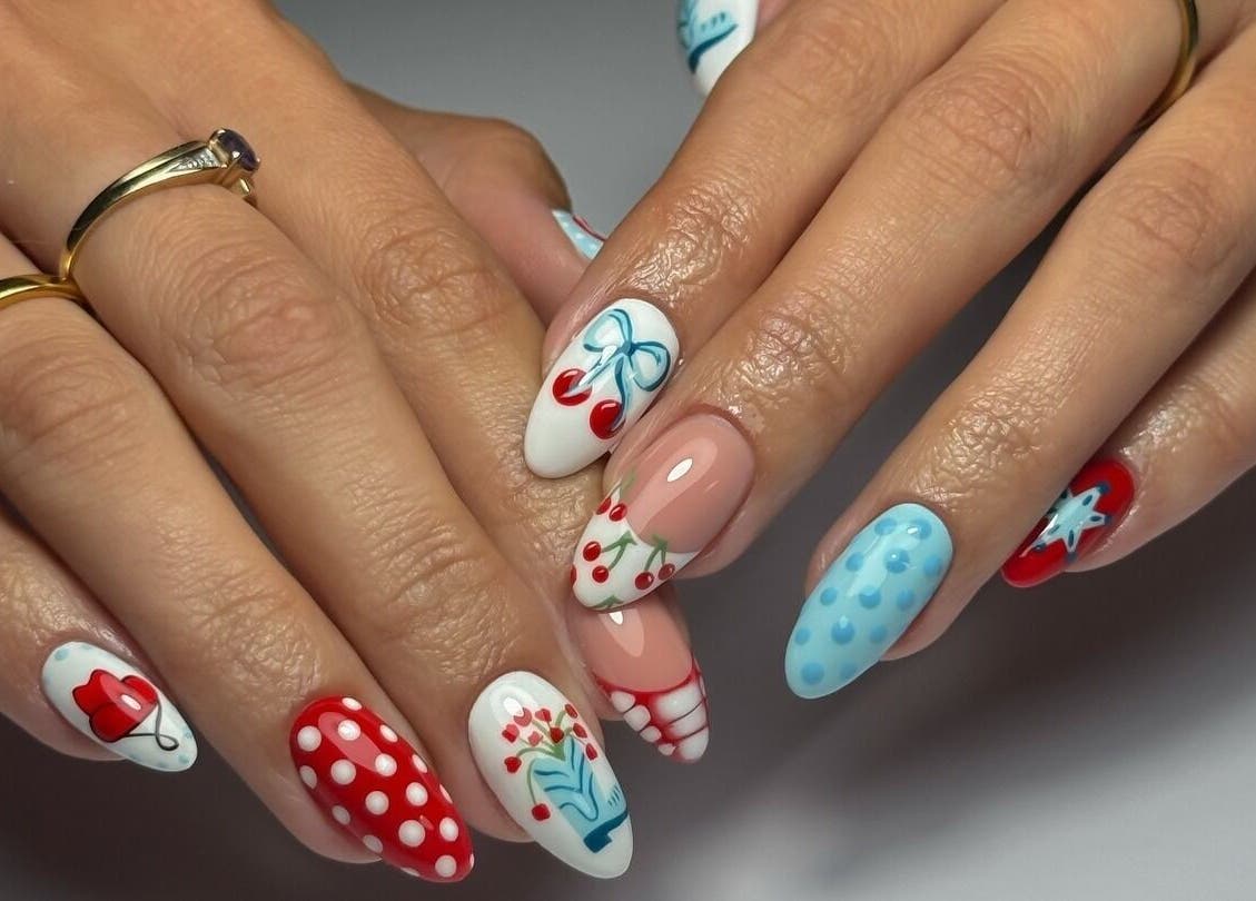 Vibrant nail art at Cupid Nail Studio, Varsity Lakes, Queensland, AU, featuring cherry and polka dot designs.